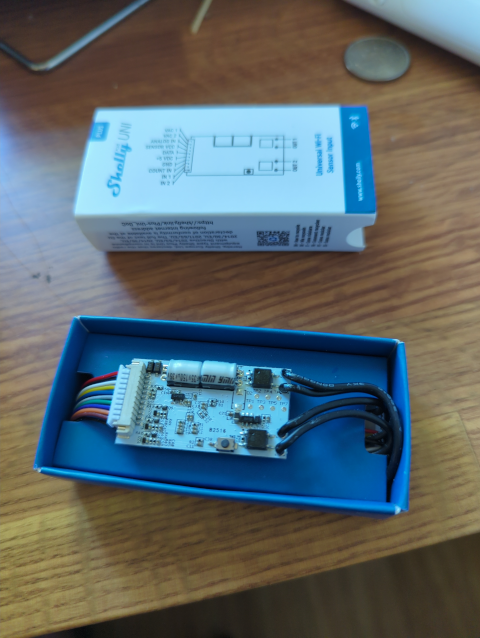 photo of the Shelly Plus Uni board still in its factory box