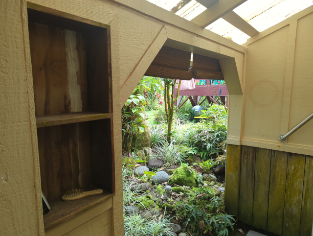 photo showing the outdoor shower from the inside with the new shades raised