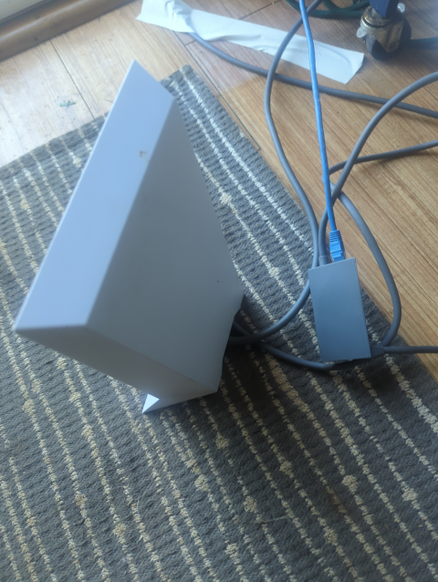 photo of the back of a Starlink base station showing the Ethernet adapter
