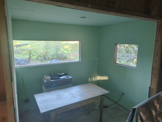 photo of the inside of the studio with some greenboard hung but not yet taped