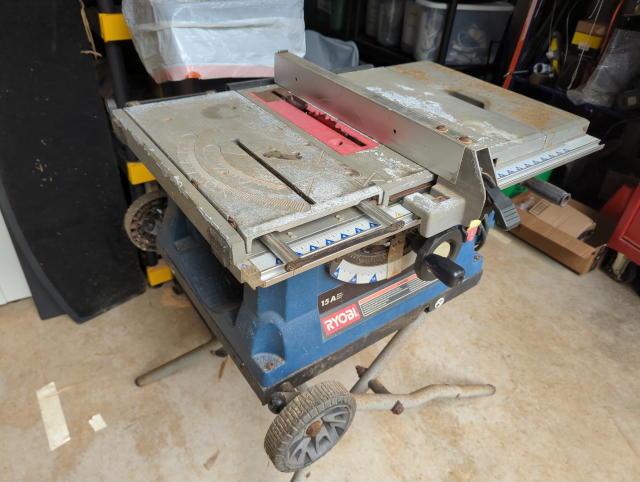 photo of a well-worn Ryobi portable table saw