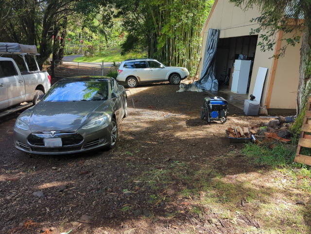 photo of an electric car being charged by a gasoline-powered generator