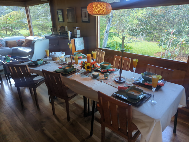 photo of a table set for seven with lobster bisque and cocktails