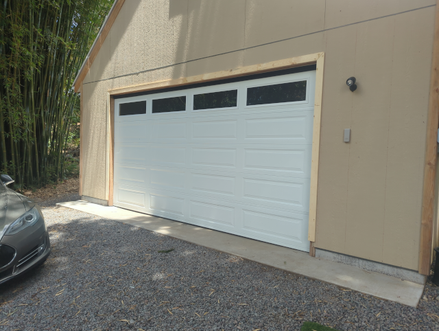 photo of the garage, now with wood trim around the door