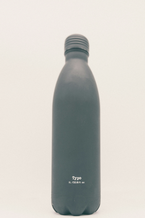 photograph of a green water bottle with the word "Typo" printed in white letters above the capacity: "1L/33.81 fl. oz"